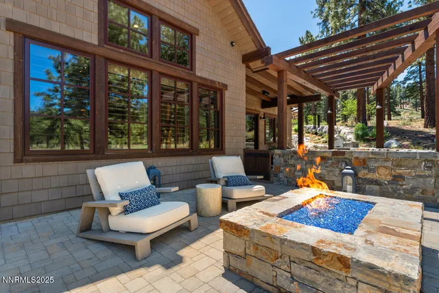 a view of a patio with a dining table and chairs with wooden floor