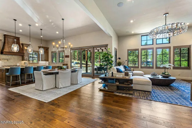 a living room with fireplace furniture and a large window