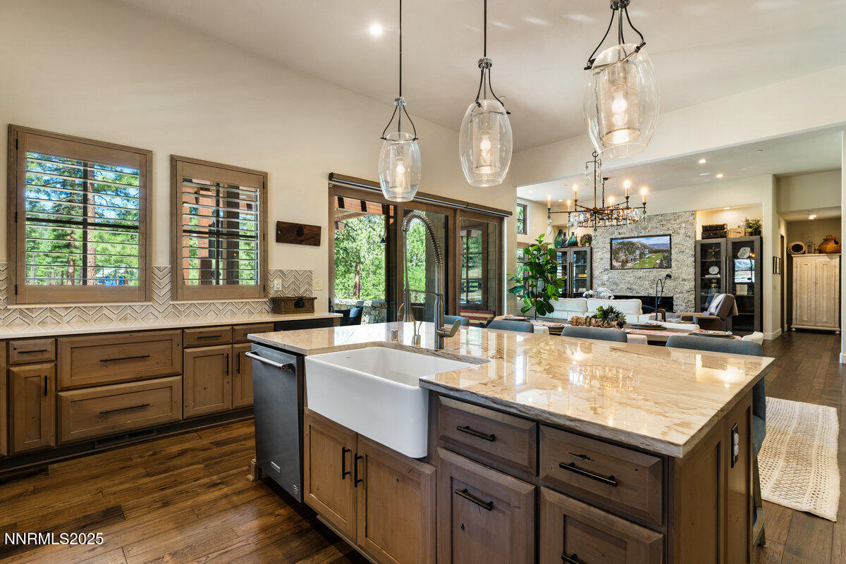 253 Mill Race Loop Carson City, NV 89705 - Photo 6 of 44 a large kitchen with kitchen island a large island in the center and stainless steel appliances