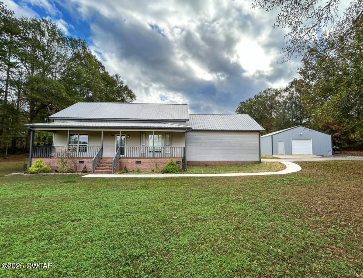 1180 Mayfield Road Finger, TN 38334 - Photo 1 of 1 a view of a house with a yard porch and sitting area