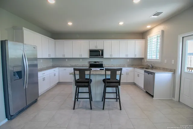 a kitchen with a refrigerator and microwave