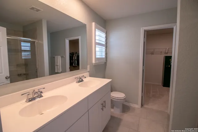a bathroom with a sink toilet and mirror