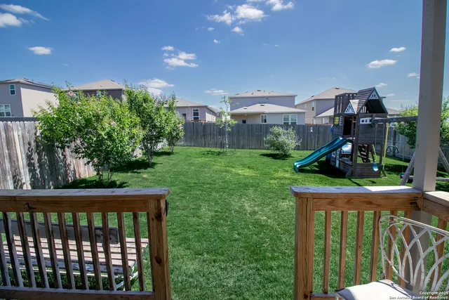 a view of a porch with furniture and garden view