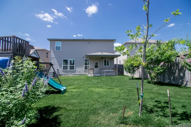 a view of a house with a backyard and a patio