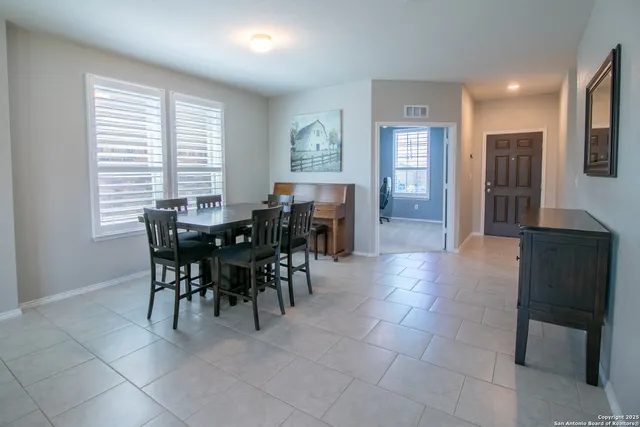 a view of a dining room with furniture and window