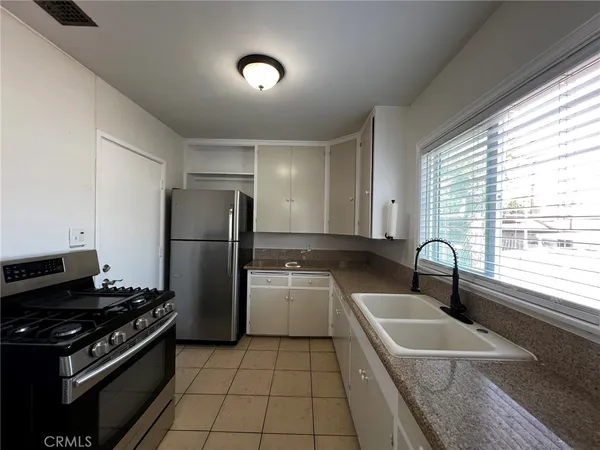 a kitchen with a sink stove and refrigerator