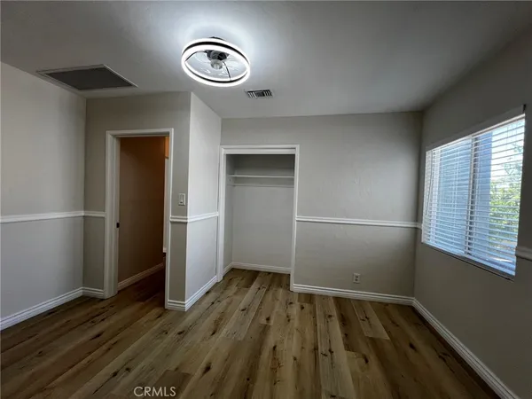 a view of room with window and hardwood floor
