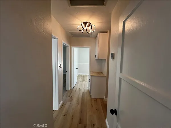 a view of a hallway with wooden floor