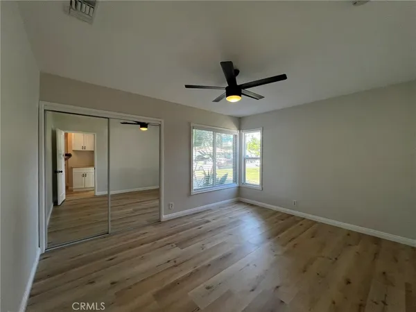 wooden floor in an empty room with a window