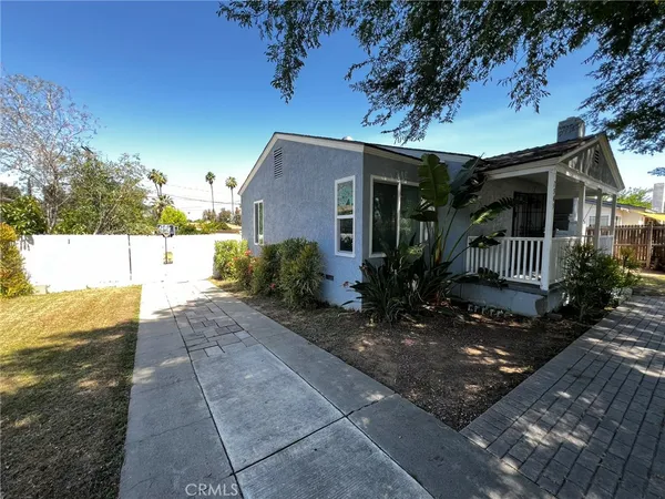 a view of house with backyard space and garden