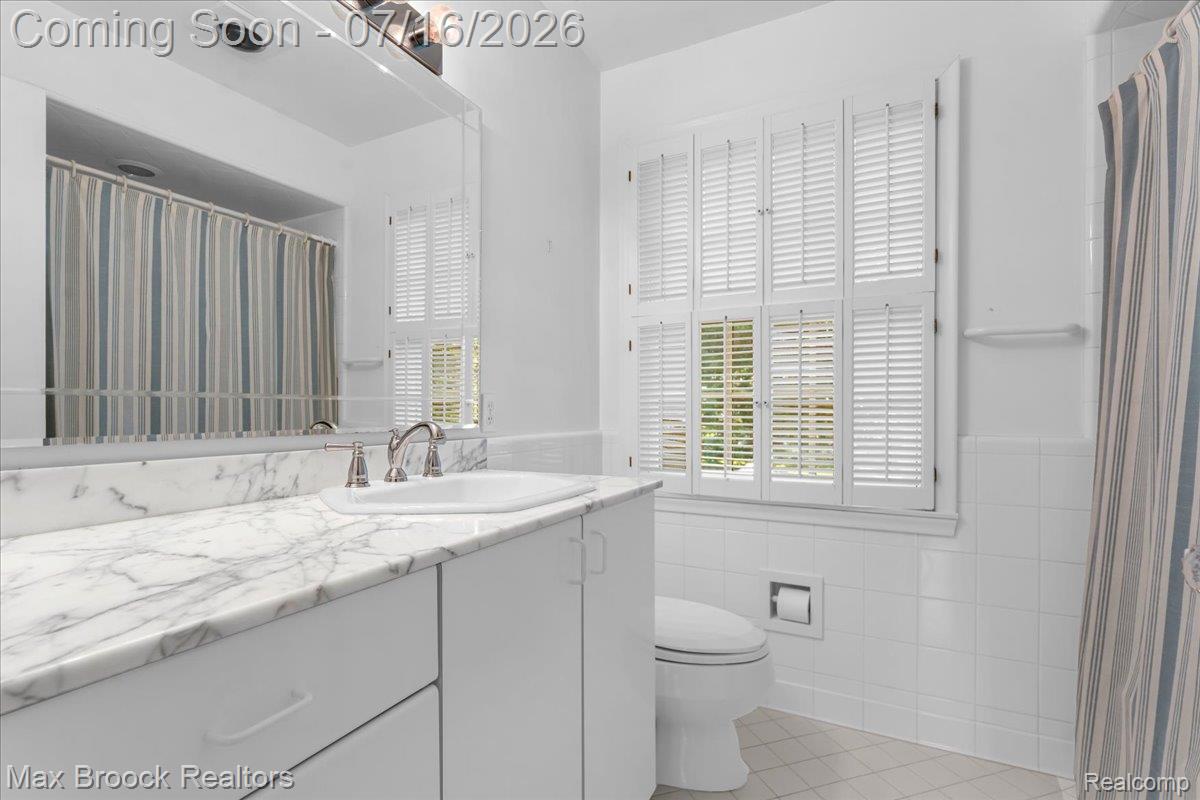 1292 Yorkshire Road Birmingham, MI 48009 - Photo 27 of 47 Bathroom featuring a vanity with a white stone countertop, integrated sink, and brushed nickel faucet