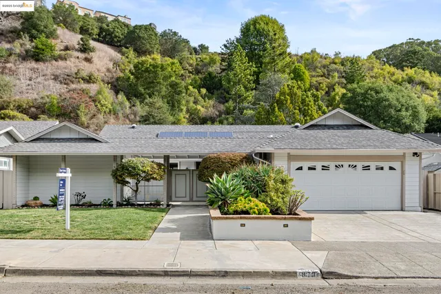a front view of a house with a yard and a garage