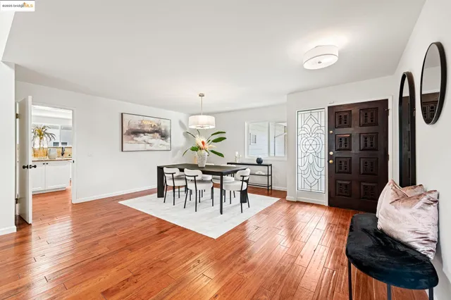 a view of a dining room with furniture window and wooden floor