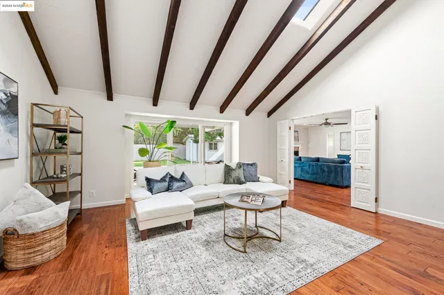 a living room with furniture a window and a fireplace