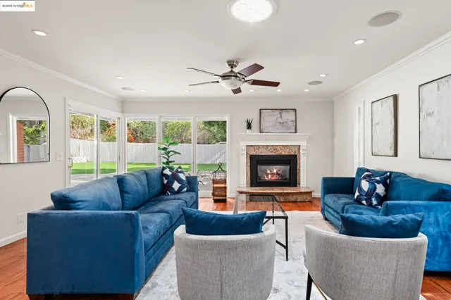 a living room with furniture and kitchen view