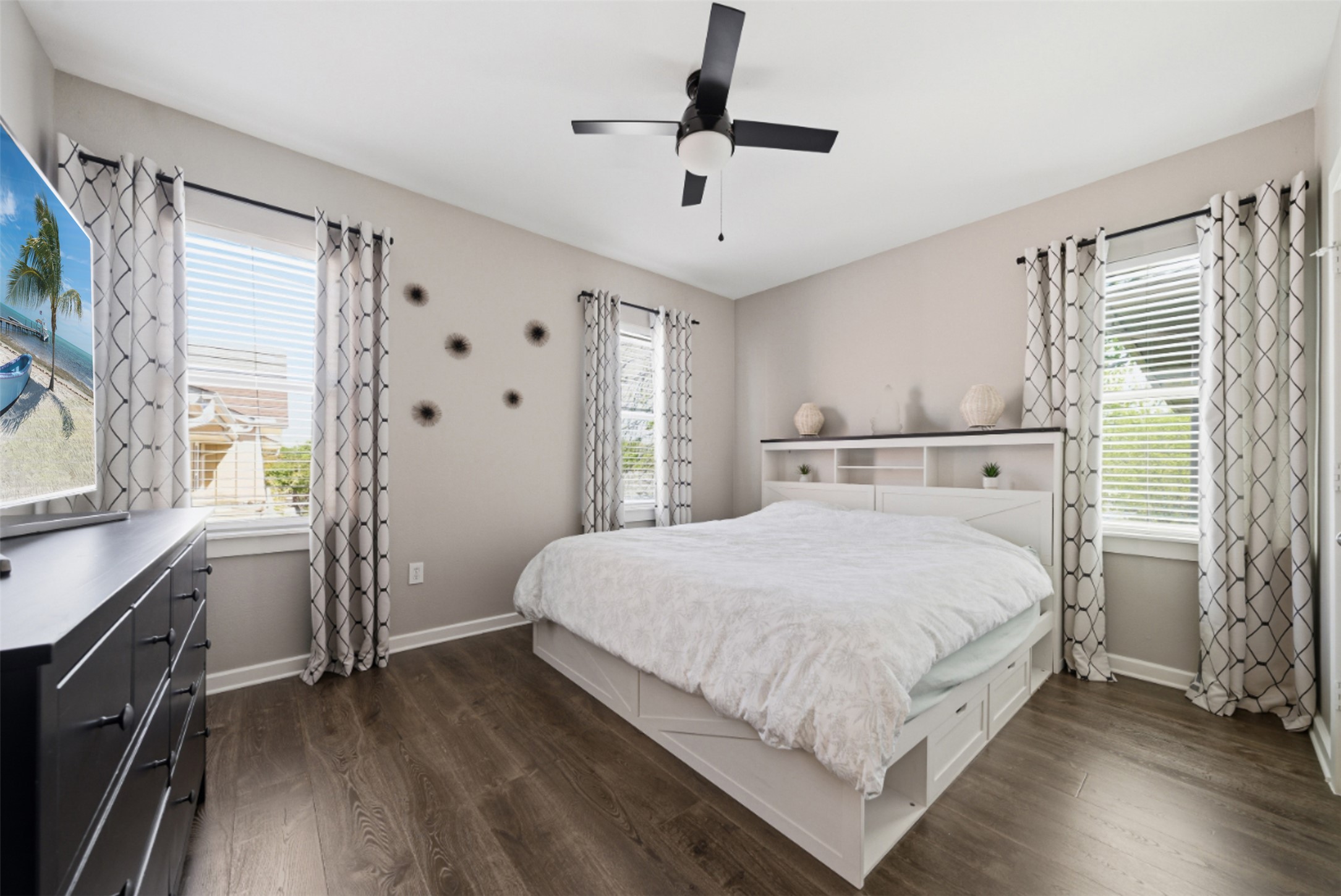 1201 Grove Boulevard, Unit 1304 Austin, TX 78741 - Photo 12 of 19 a bedroom with a bed and a flat tv screen on dresser