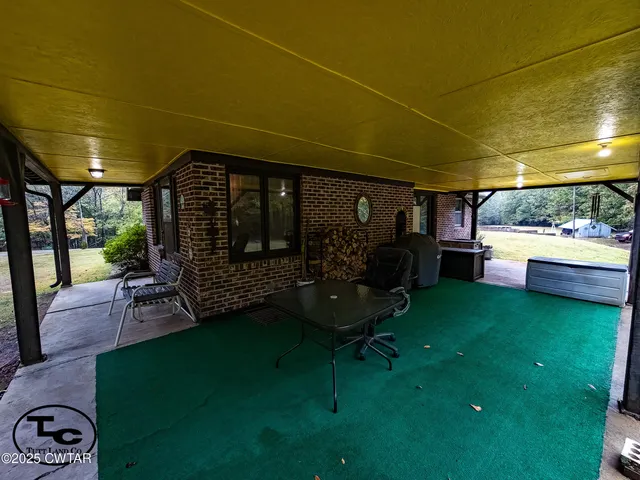 a view of a room that has a couch and a chandelier