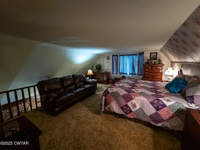 a bed room with a bed and a lamp