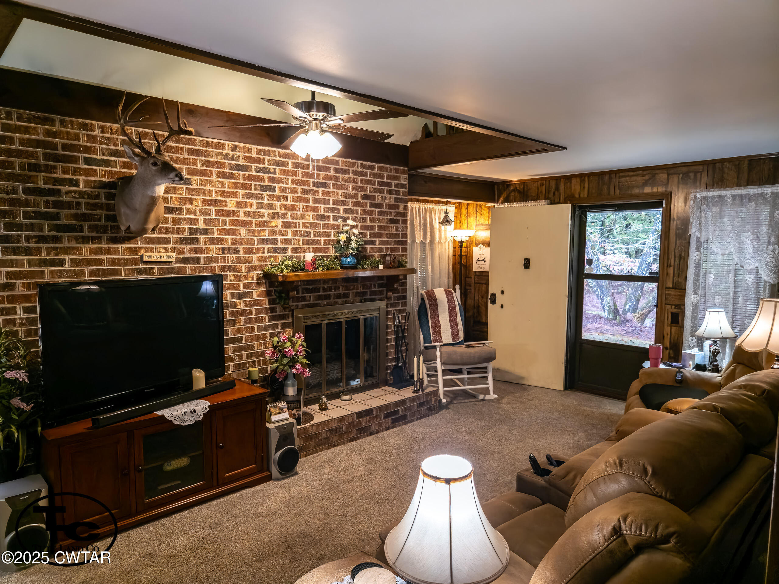 3964 Center Hill Road Finger, TN 38334 - Photo 24 of 31 a living room with furniture a flat screen tv and a fireplace
