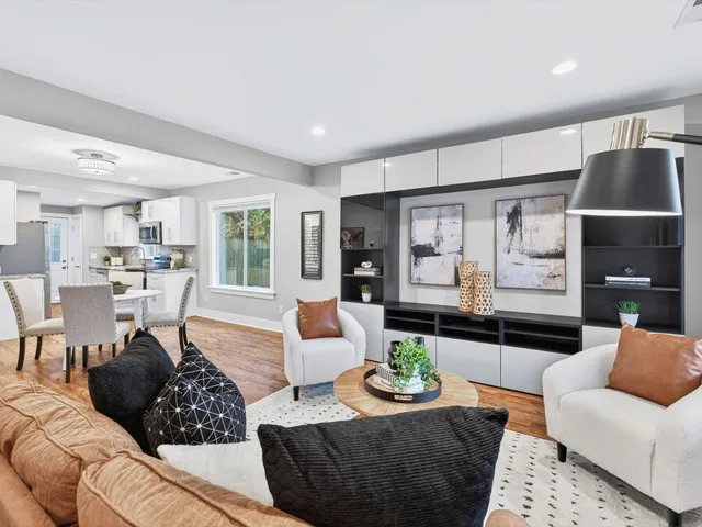 a living room with furniture and wooden floor