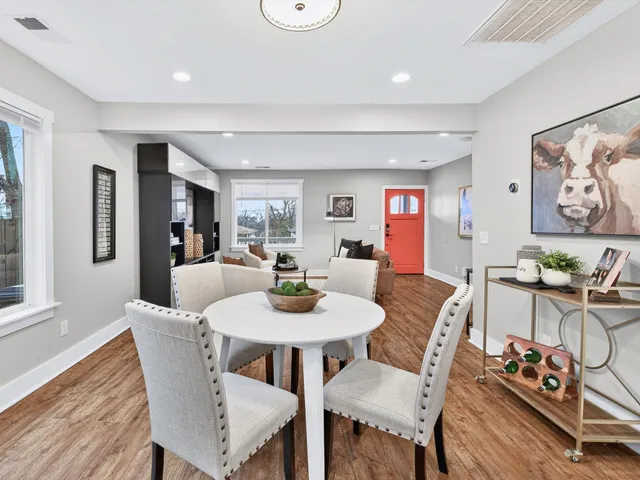a view of a dining room with furniture and wooden floor