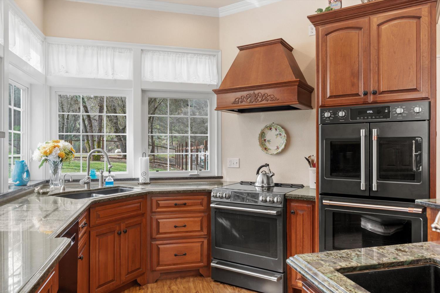 2661 Oak Ln Drive Rescue, CA 95672 - Photo 11 of 69 a kitchen with granite countertop a stove and a sink