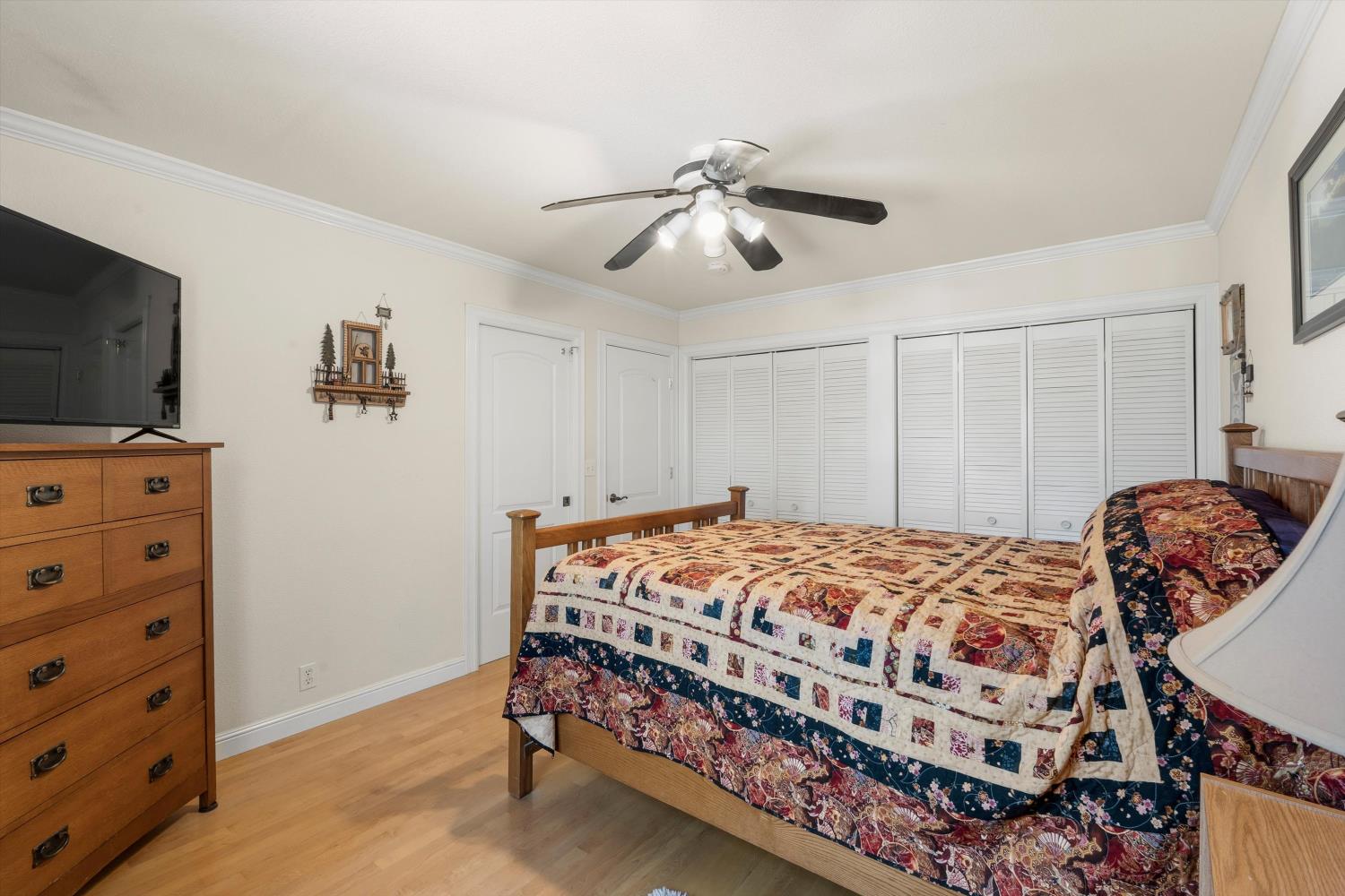 2661 Oak Ln Drive Rescue, CA 95672 - Photo 32 of 69 a bedroom with a bed and a flat tv screen on the dresser