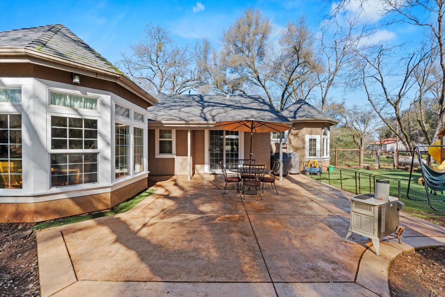 2661 Oak Ln Drive Rescue, CA 95672 - Photo 45 of 69 a view of a house with backyard sitting area and porch