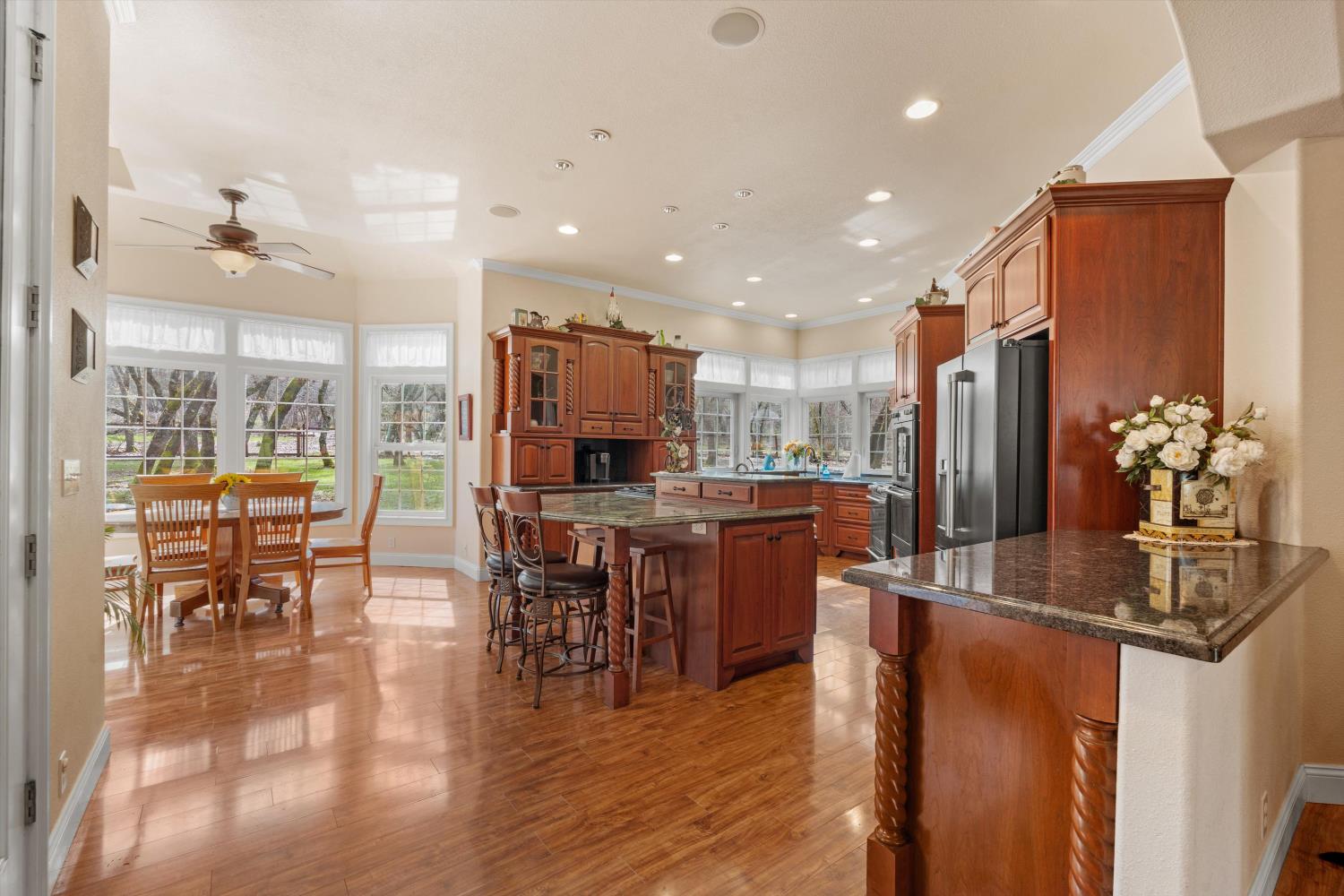 2661 Oak Ln Drive Rescue, CA 95672 - Photo 9 of 69 a kitchen with stainless steel appliances granite countertop sink refrigerator dining table and chairs