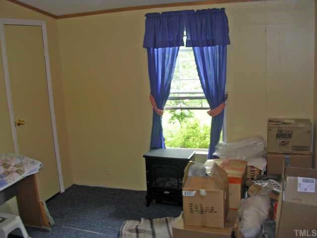 153 Stoney Mountain Road Rougemont, NC 27572 - Photo 8 of 12 a room with a window and a fireplace