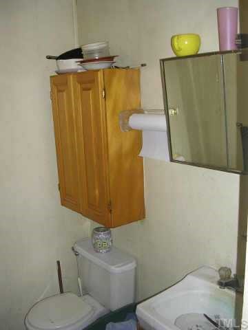 153 Stoney Mountain Road Rougemont, NC 27572 - Photo 10 of 12 a bathroom with a sink toilet and vanity