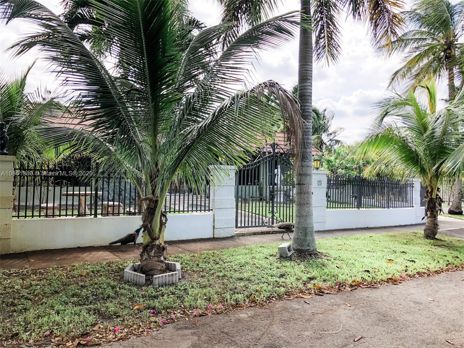 70 Samana Drive Miami, FL 33133 - Photo 2 of 10 a front view of a house with a garden