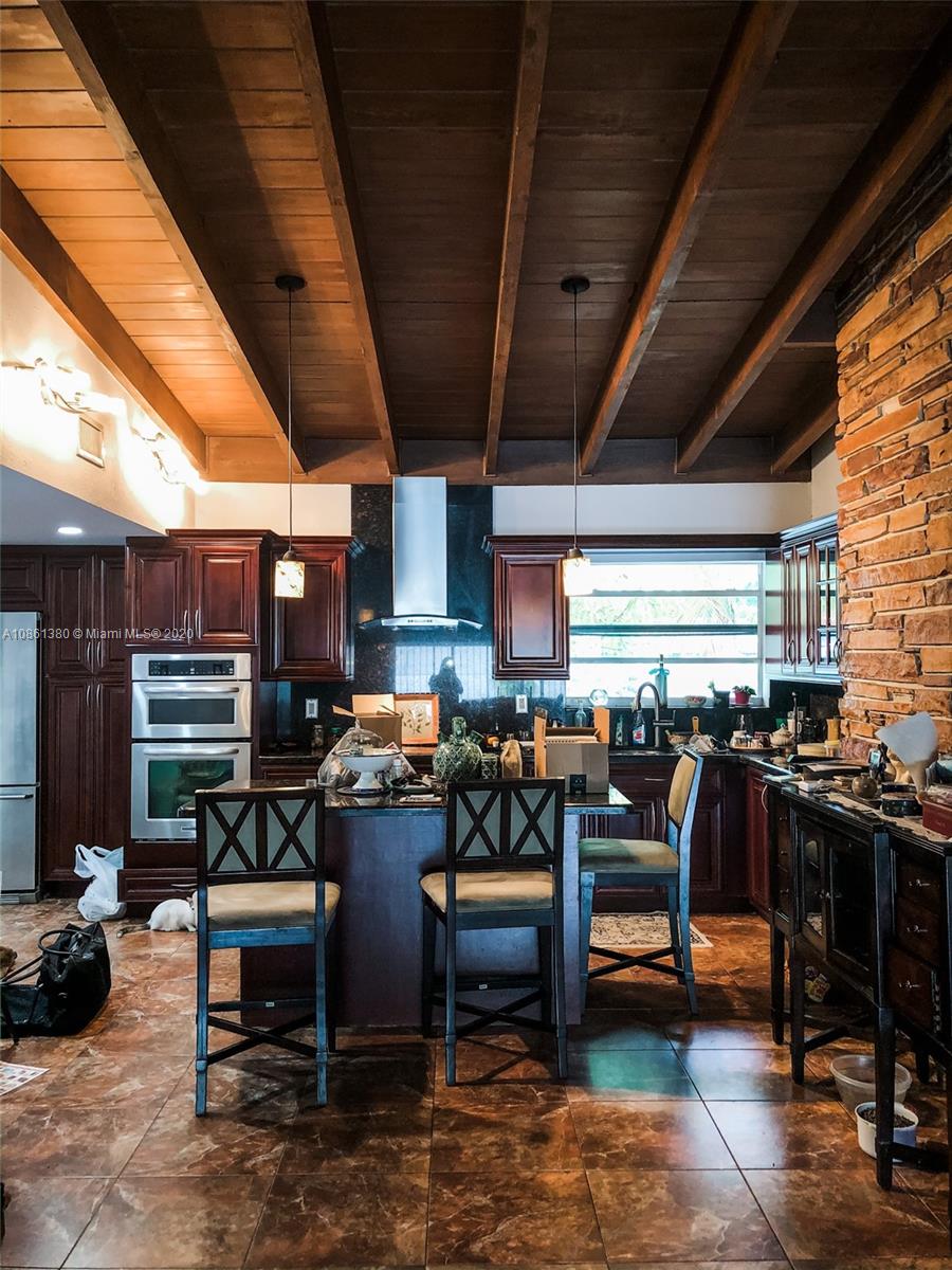 70 Samana Drive Miami, FL 33133 - Photo 7 of 10 a outdoor space with lots of chairs a sink and a stove