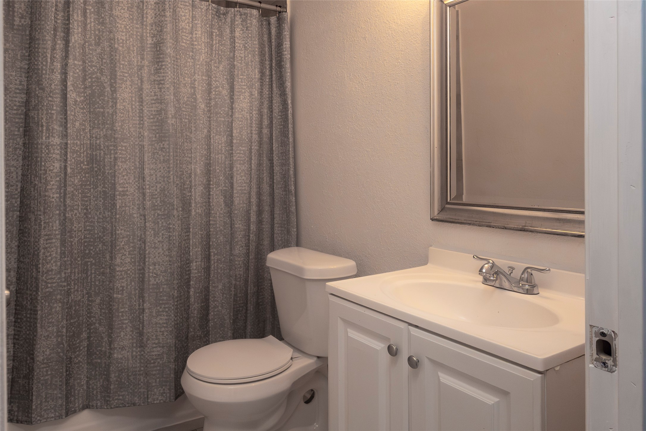 716 Hargest Street, Unit B Prairie View, TX 77445 - Photo 5 of 11 a bathroom with a sink a toilet and a mirror
