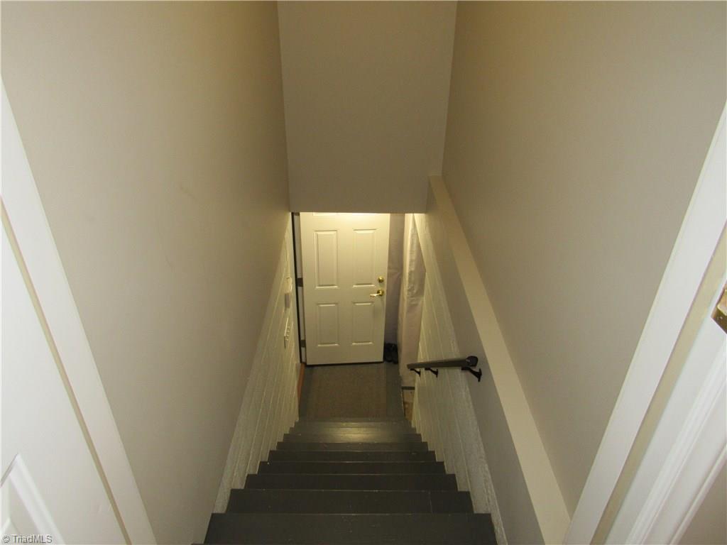 306 Summit Road High Point, NC 27265 - Photo 25 of 27 Stairs to basement off the main hallway near the living room. The door at the base of the stairs goes to the garage - turn right and you are in the unfinished workshop that has an exterior door.