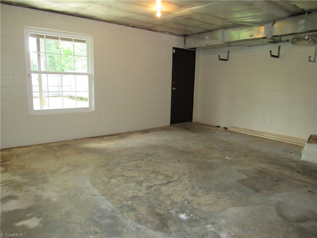 306 Summit Road High Point, NC 27265 - Photo 27 of 27 Basement workshop. Hanging racks and peg board do not convey.