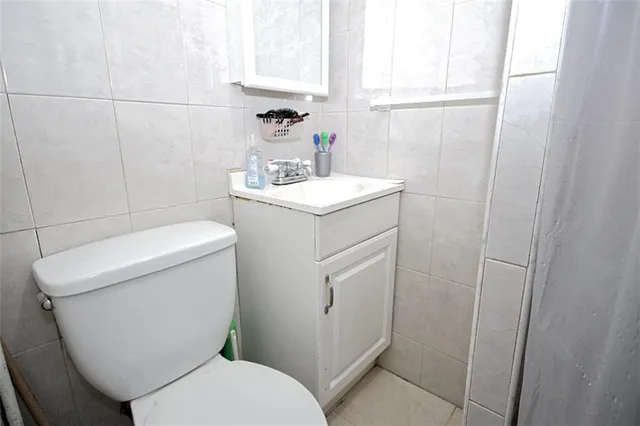 a white toilet sitting next to a bathroom sink