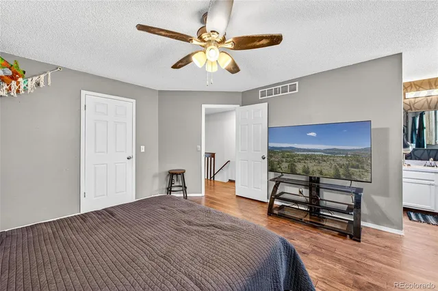 a bedroom with a bed and a dresser next to a window