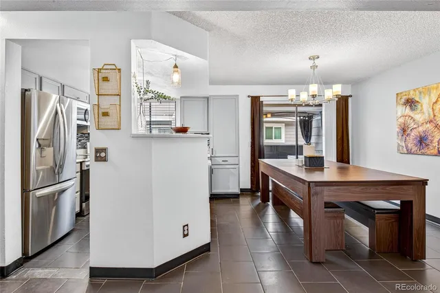 a kitchen with stainless steel appliances granite countertop a refrigerator a stove and a sink