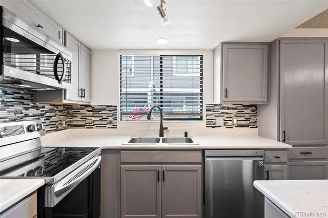 a kitchen with kitchen island a sink stove and cabinets