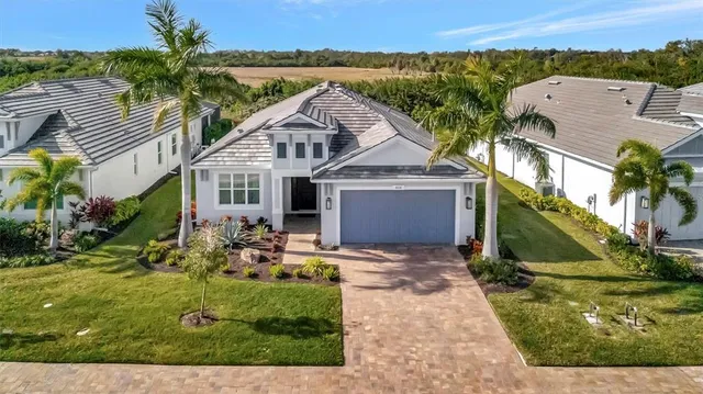 an aerial view of a house with a garden and plants