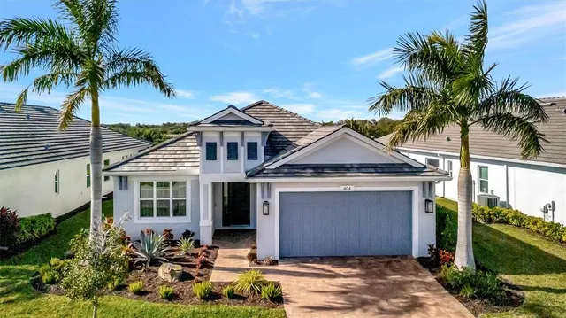 a front view of a house with a garden and yard