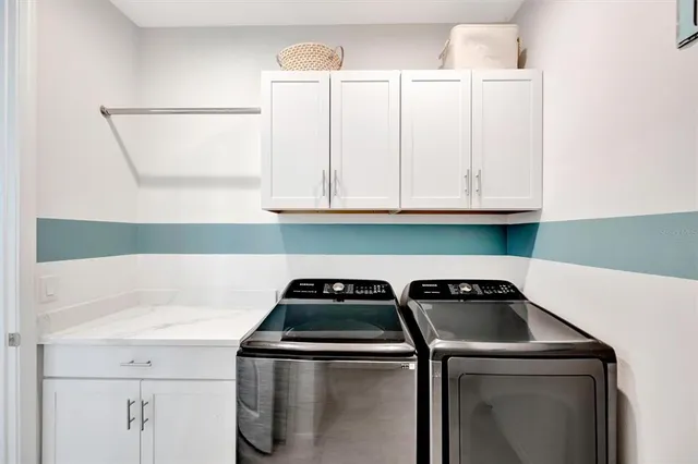 a utility room with dryer and stove