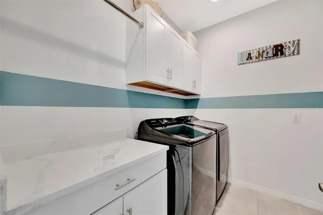 a spacious bedroom with a bed and a dresser