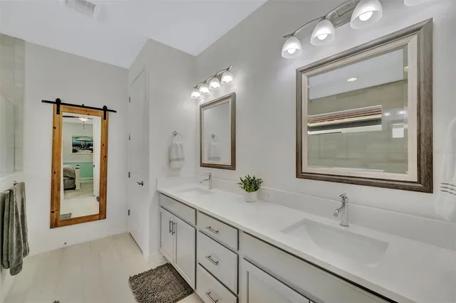a spacious bathroom with a double vanity sink and a mirror