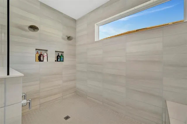 a bathroom with a tub sink and mirror