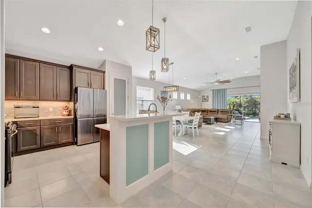 a view of kitchen with sink microwave and refrigerator