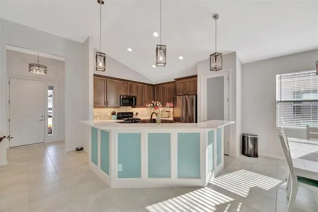 a kitchen with kitchen island a sink stove and refrigerator