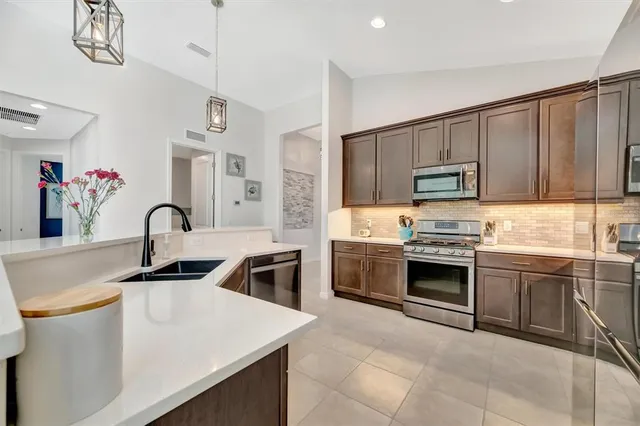 a kitchen with a sink stove and cabinets