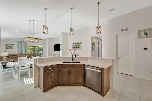 a kitchen with a sink and a stove top oven